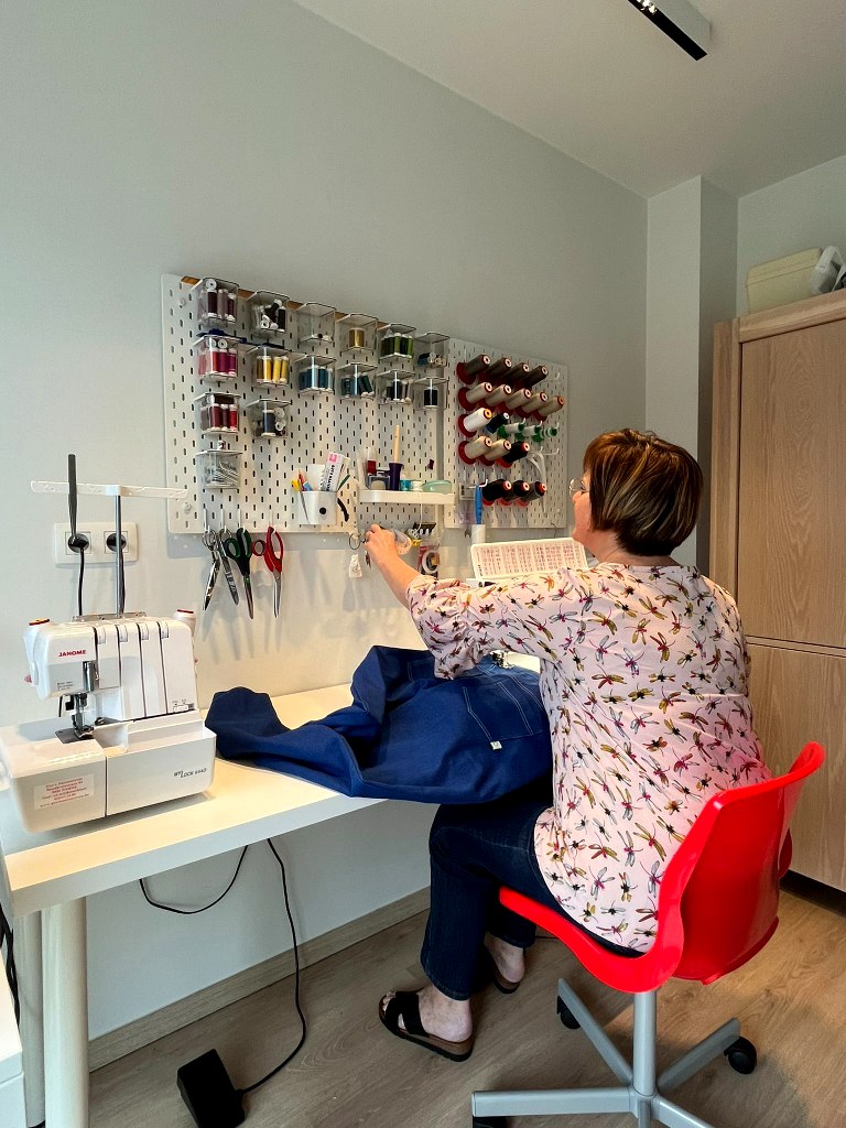 Helga aan de naaimachine in het atelier